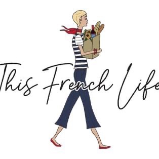 Illustration of a woman wearing red scarf and shoes, striped shirt, and navy pants, carrying a bag with wine, flowers, and baguettes. The words “This French Life” appear in script across her.