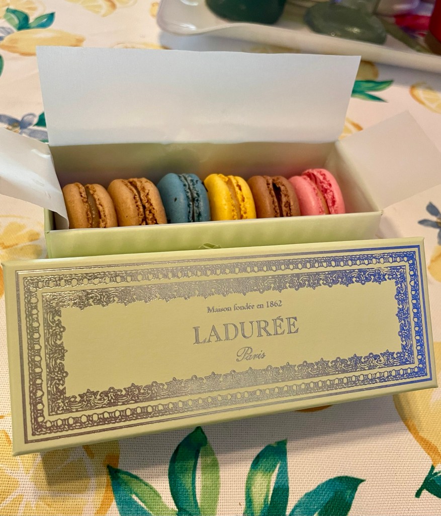 Open box of Ladurée macarons in various colours.