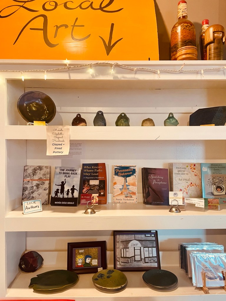 Display of local art and books, including “Provenance Unknown” by author Sonia Nicholson. 