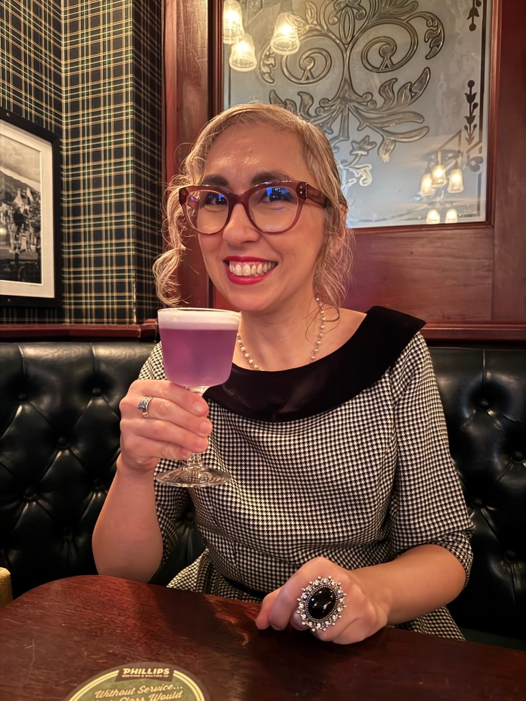 Author Sonia Nicholson holding “Midnight in Paris” cocktail. 