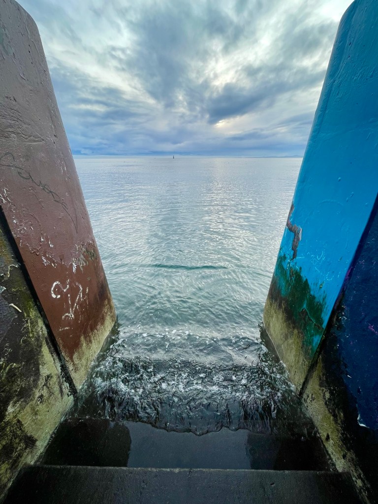 Opening between walls to ocean, Dallas Road, Victoria, BC, January 2026. Photo by author Sonia Nicholson.