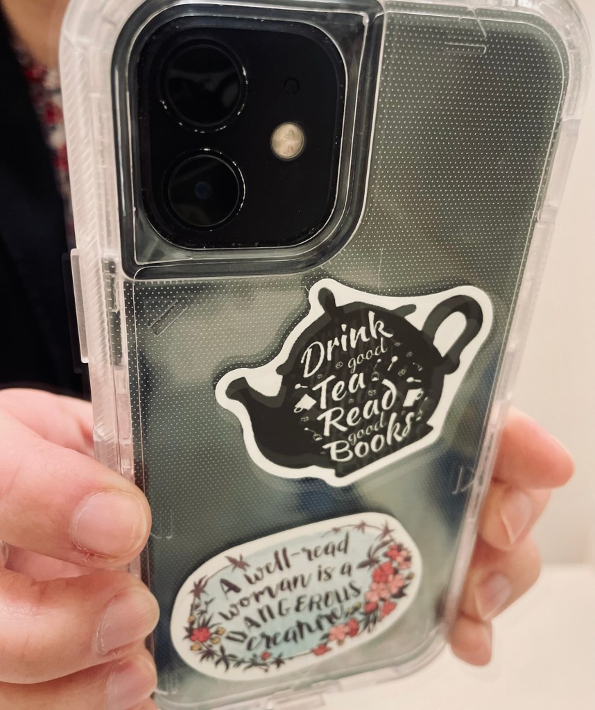 Phone case with stickers: 1) "Drink good tea, read good books" 2) "A well-read woman is a dangerous creature"