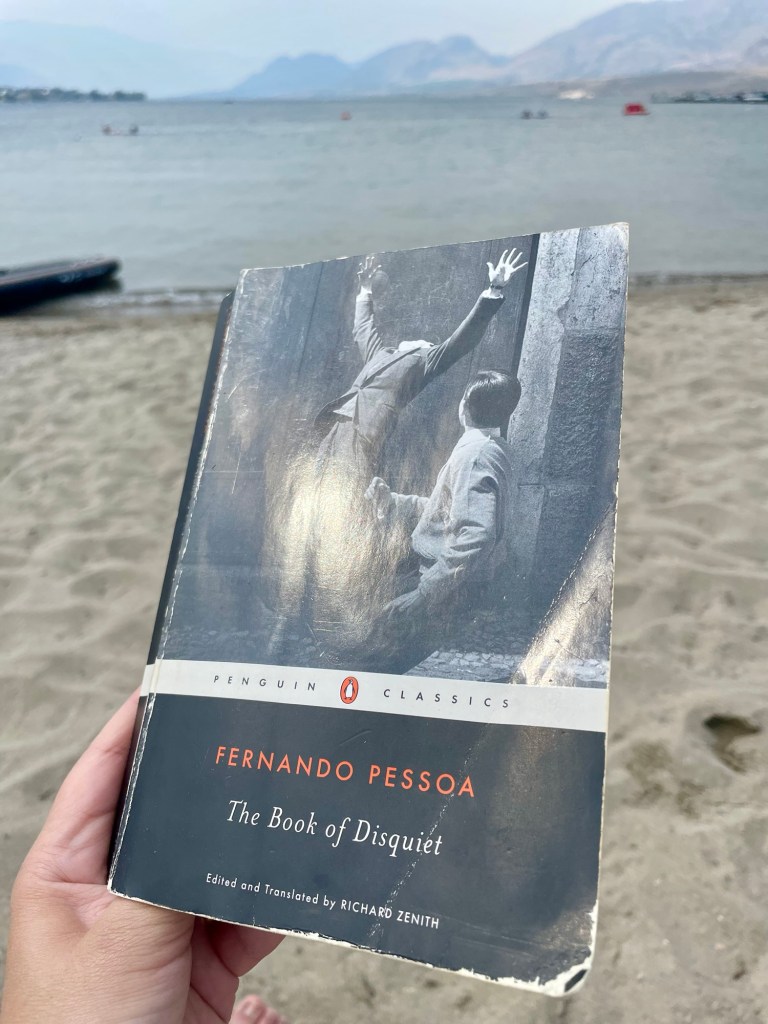Holding a copy of Fernando Pesso's The Book of Disquiet. Photo by Sonia Nicholson.